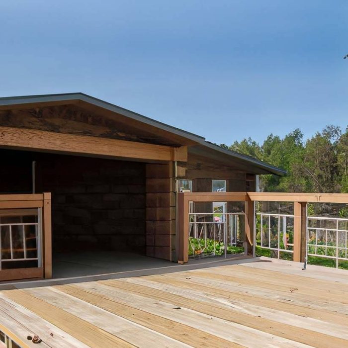 Decks and Porch Construction , we can see some green trees in the background