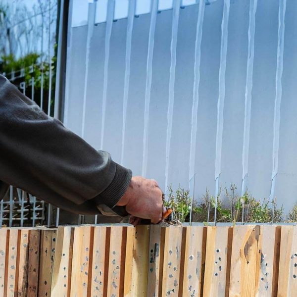 a perdon doing Fence Installation , we can see is made of wood